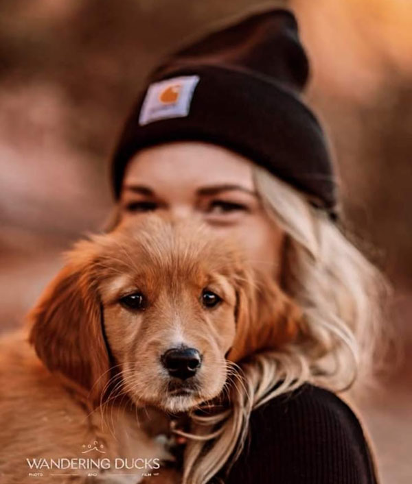 girl holding puppy